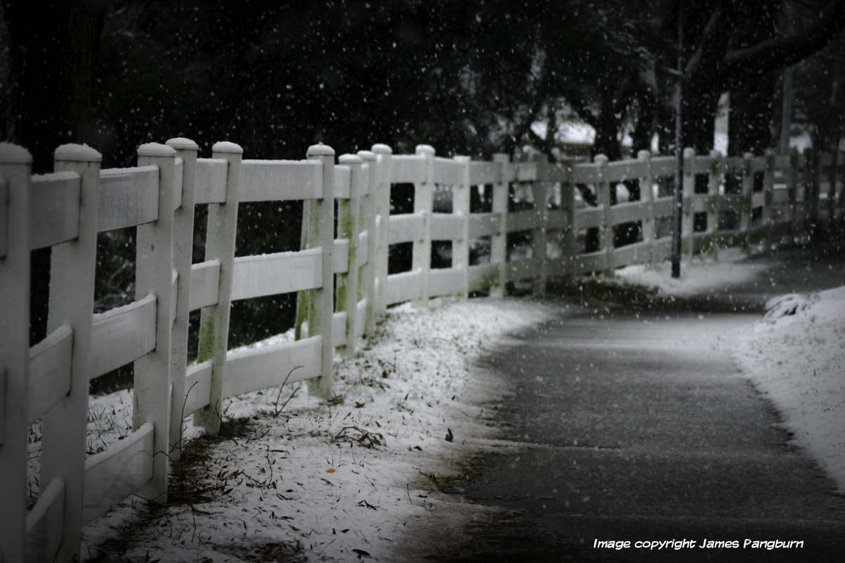 fence with snowy walkway