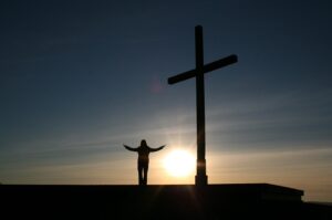 a person worshipping at the cross