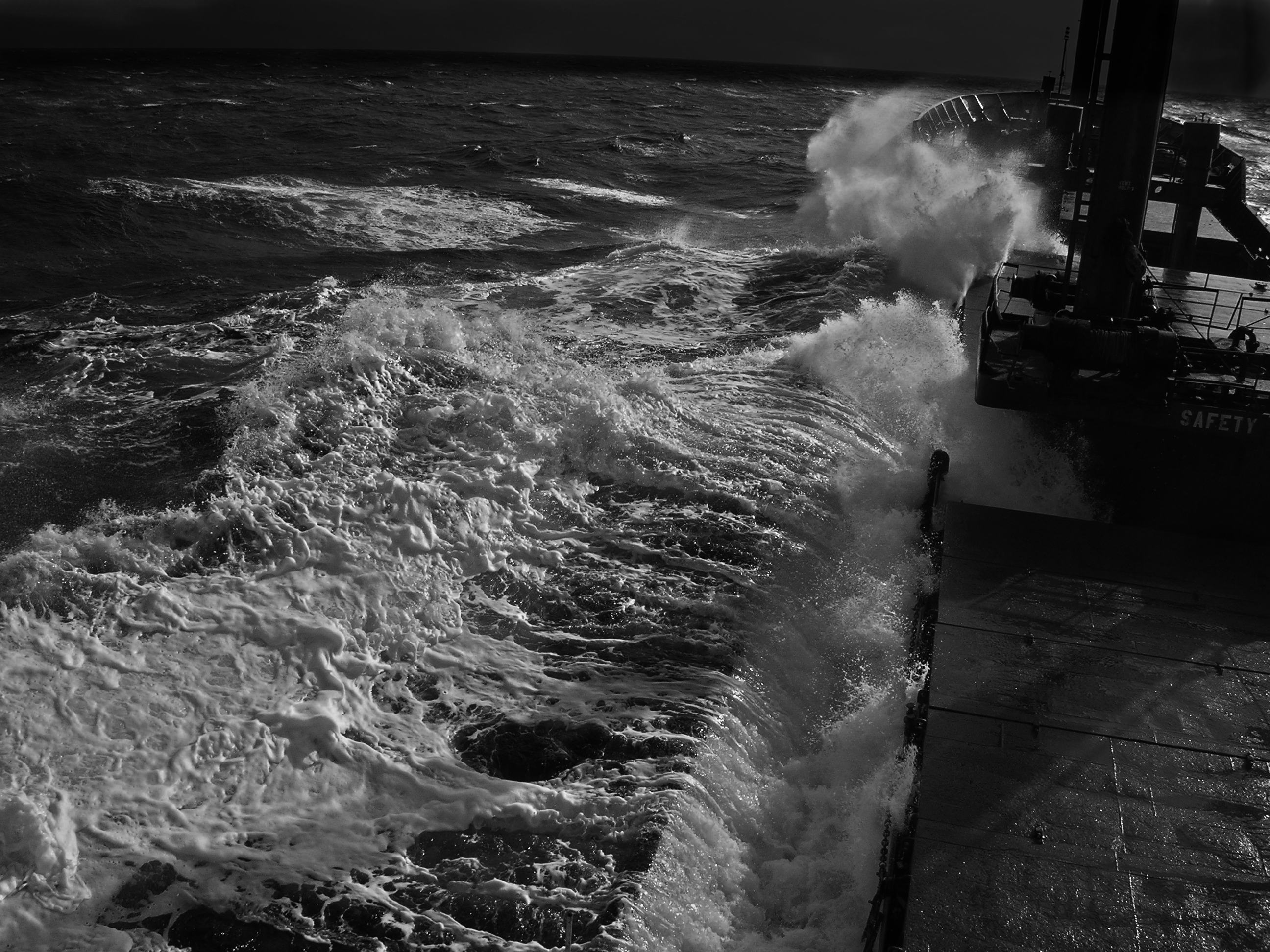 A ship moving through rough night seas symbolic of when when trust in Jesus we remain secure