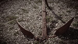 old anchor resting in stoney ground
