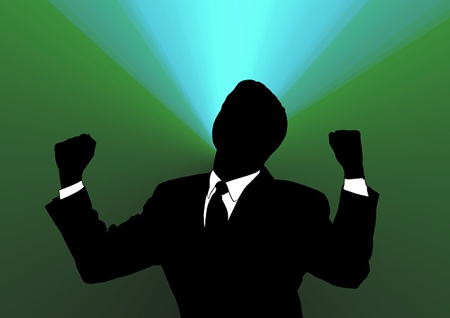a silhouette of a man with fists raised in victory
