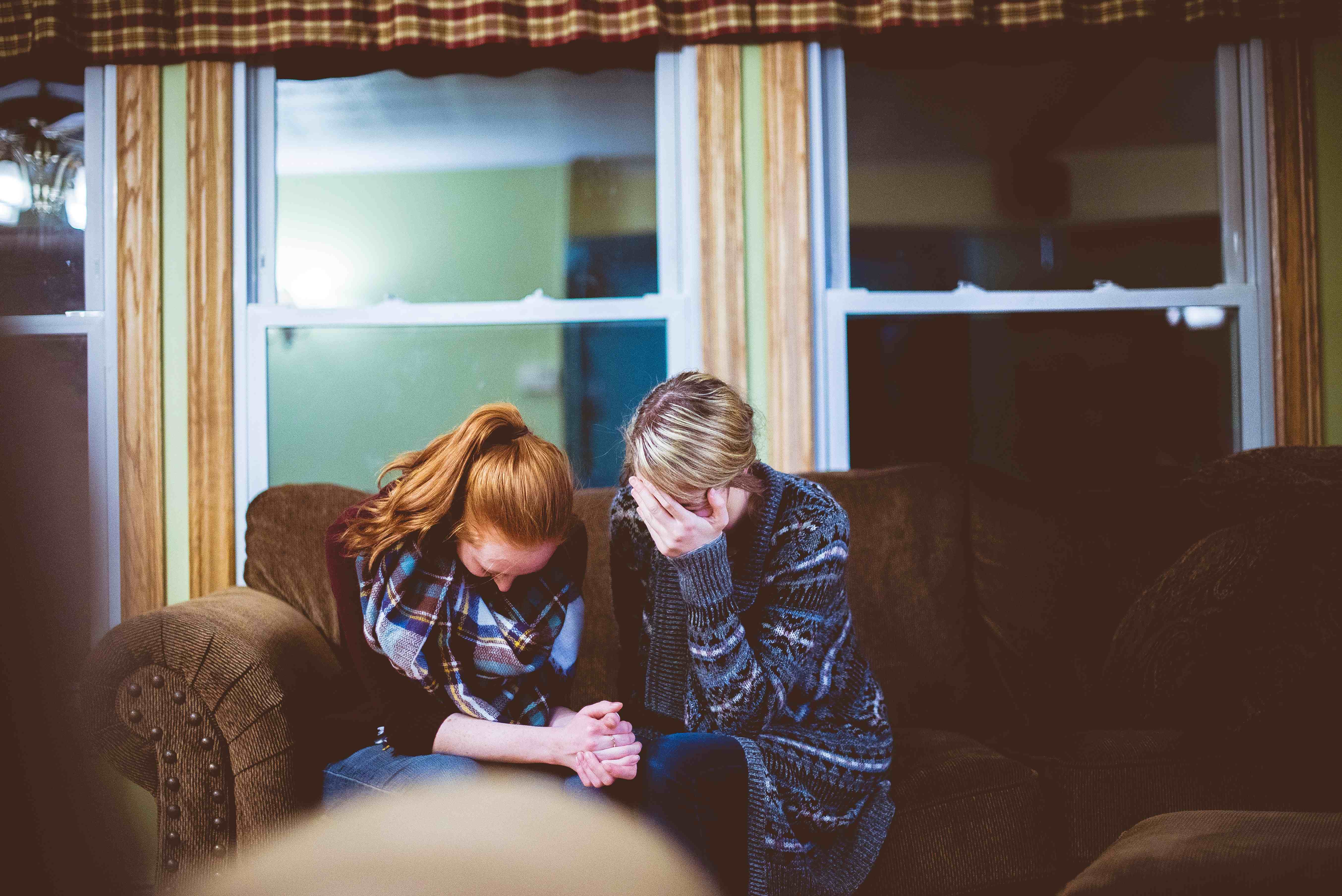two women in prayer to ask God