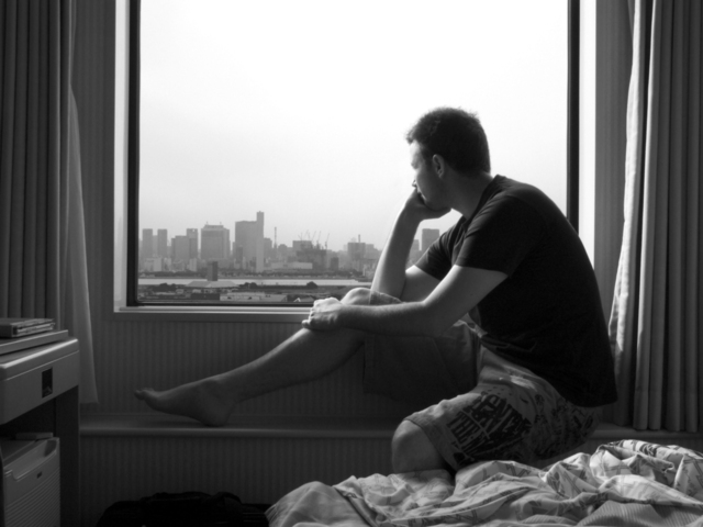man looking out window