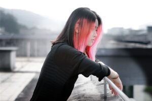 young Japanese woman looking over railing