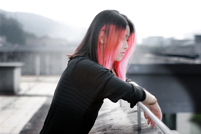 young Japanese woman looking over railing