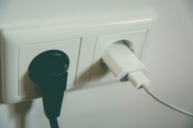 black cord and white ac adapter in non-U.S. outlet