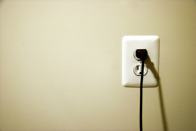 U.S. wall outlet with cord plugged in