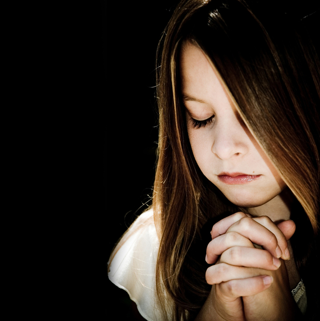 young girl praying