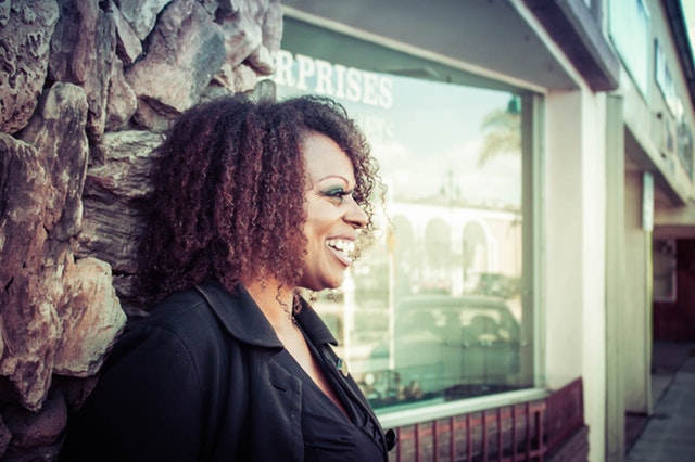 side headshot of a happy African American woman possibly laughing