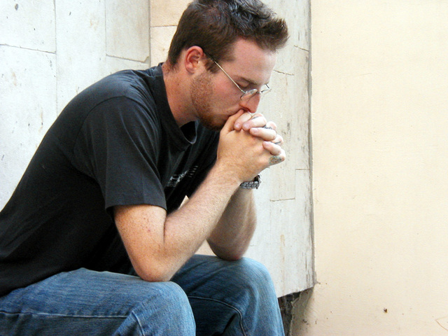 man seating praying