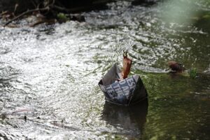 paper boat floating on stream