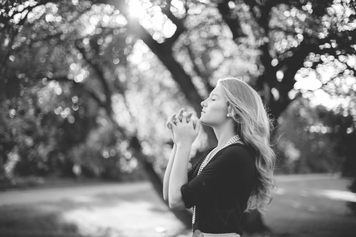 A woman in prayer demonstrating the key to our fervent desires.