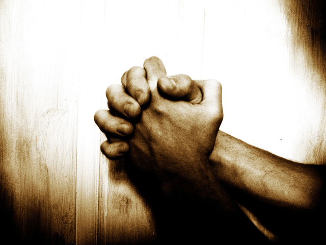 hands clasped in prayer