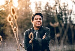 man smiling with folded arms