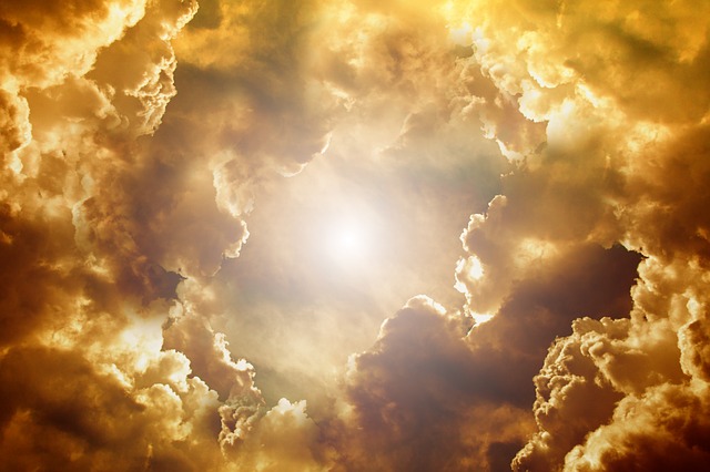 An image of sun streaming through brownish clouds, symbolizing our blessed hope