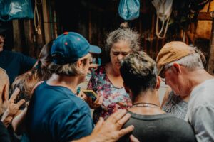 group-prayer-elianna-gill-Q588c92mWEI-unsplash(https-::unsplash.com:photos:a-group-of-people-standing-around-each-other-Q588c92mWEI)