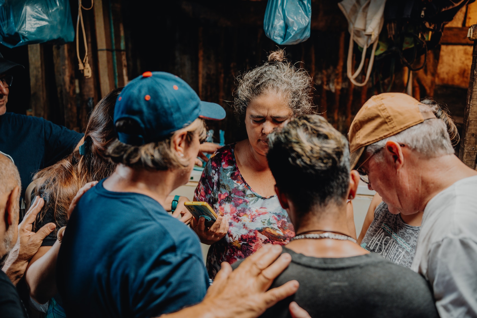 group-prayer-elianna-gill-Q588c92mWEI-unsplash(https-::unsplash.com:photos:a-group-of-people-standing-around-each-other-Q588c92mWEI)