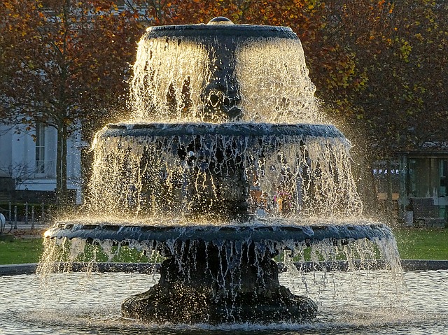A three-tiered fountain with water flowing down around it