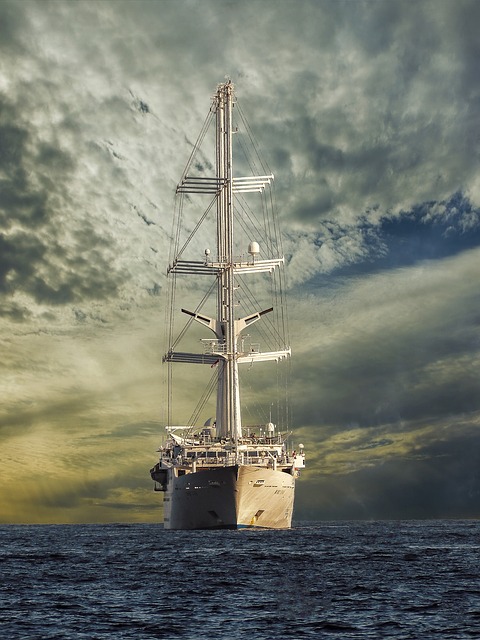 Large white modern sailing ship with sails rolled up