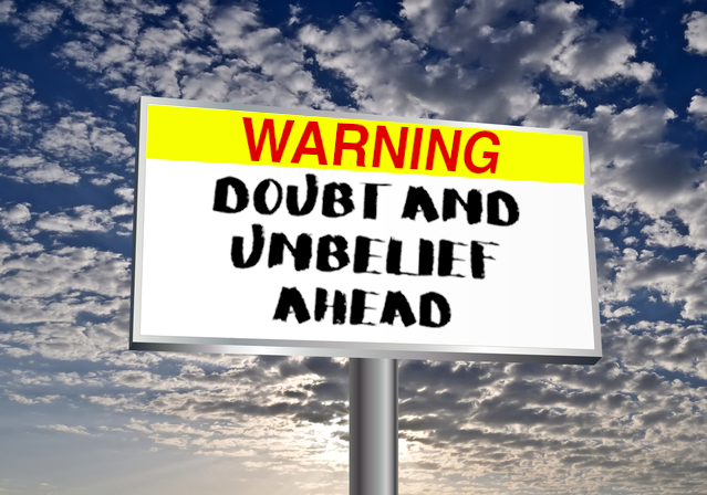 Clouds, blues sky and a billboard with words: Warning: Doubt and Unbelief Ahead