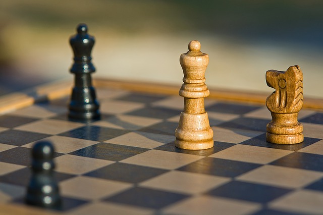 Assorted chess pieces on a board