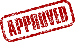 Red approved stamped on white surface