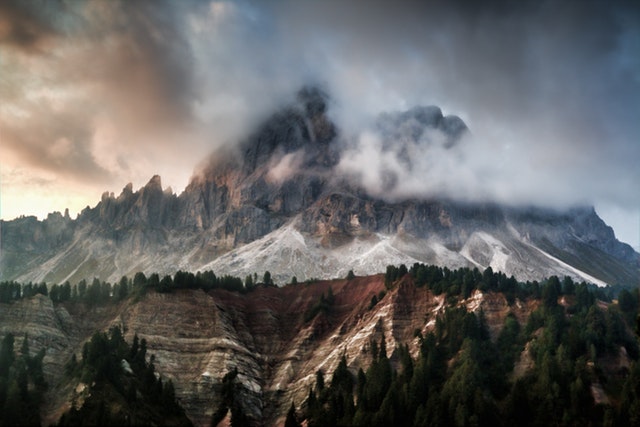Clouds obscuring top of a large mountain symbolizing our journey with God