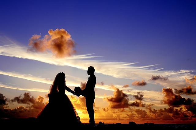 Silhouette of bride and groom with sunset behind