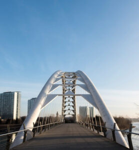 A modern steel arch suspension pedestrian bridge