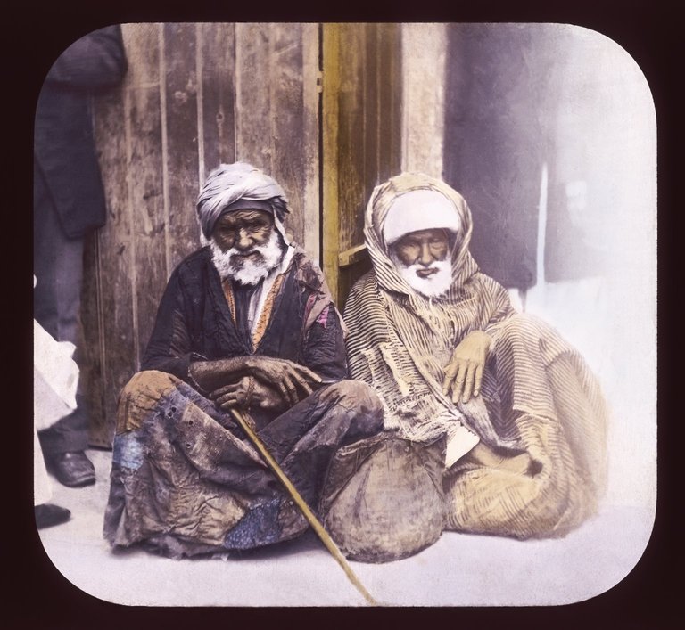 A color slide of a pair of seated beggars in Alexandria, Egypt.