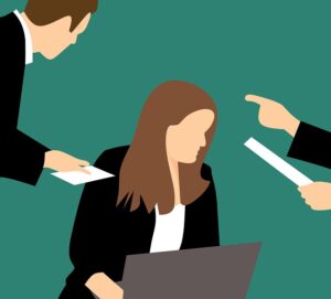 A graphic of a woman being harassed or bullied at work