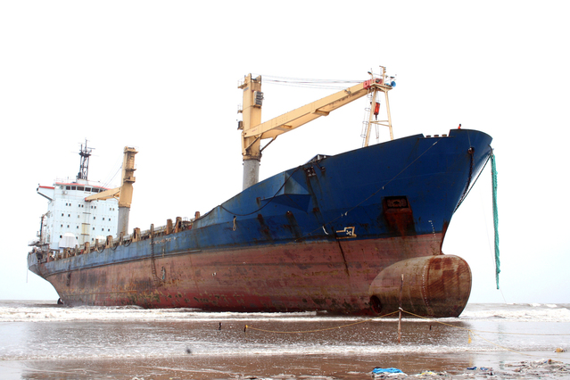 large empty container ship run aground on sand and silt representative of how sin can prevent you from moving forward