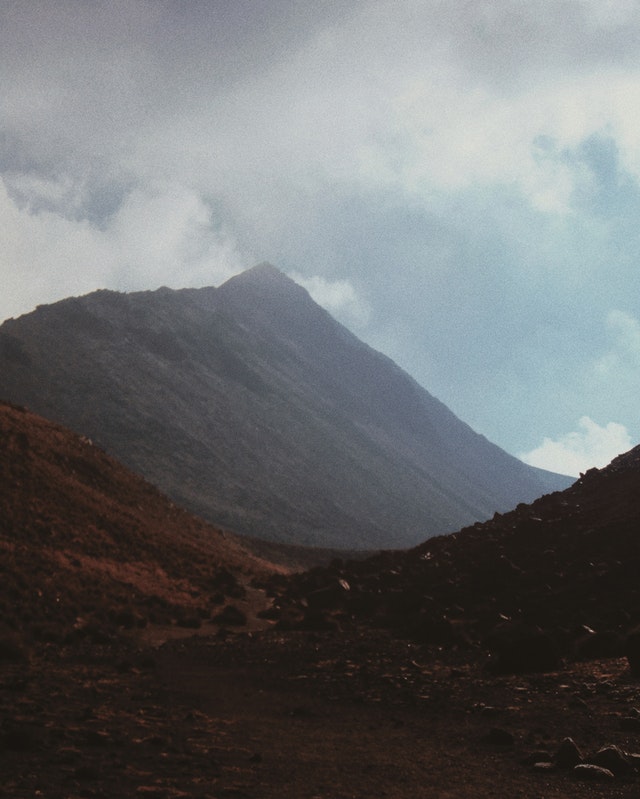 photo of desert mountain pass with fog and clouds