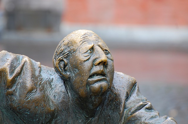 photo of sculpture of affliction at Aachen Elise Fountain of man's face in suffering