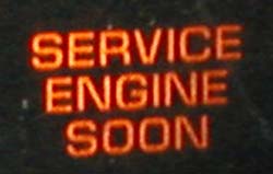 An orange/red 'service engine soon' indicator on a black background