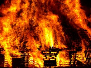 Massive flames from numerous stacks of wood pallets burning