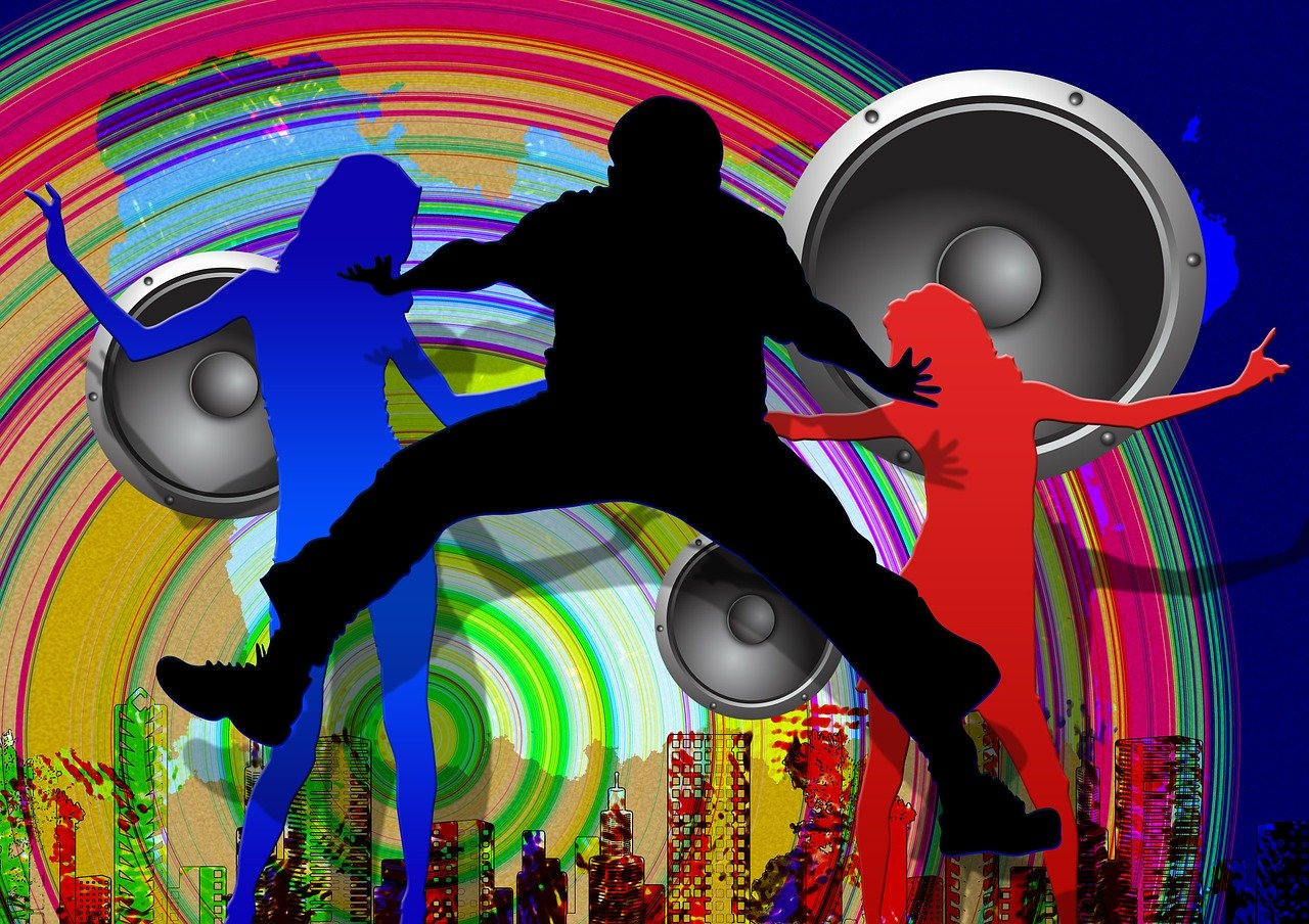 A graphical image of three silhouettes in blue, black, and red respectively of people dancing with a rainbow colored swirling disc, three large silver grey loudspeakers, and other assorted urban graphics behind them