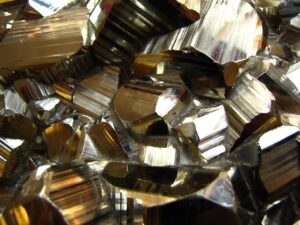 A close-up photo of a cluster of shiny pyrite