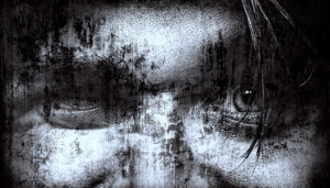 A black and white image of the cropped face of a man with one eye partially obscured and a small amount of hair over the other and an a rough overall appearance in the skin