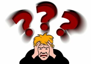 A graphical image of a Caucasian man with blond hair holding his hands against the sides of his face with an expression of despair and distress on it and three large red question marks above his head
