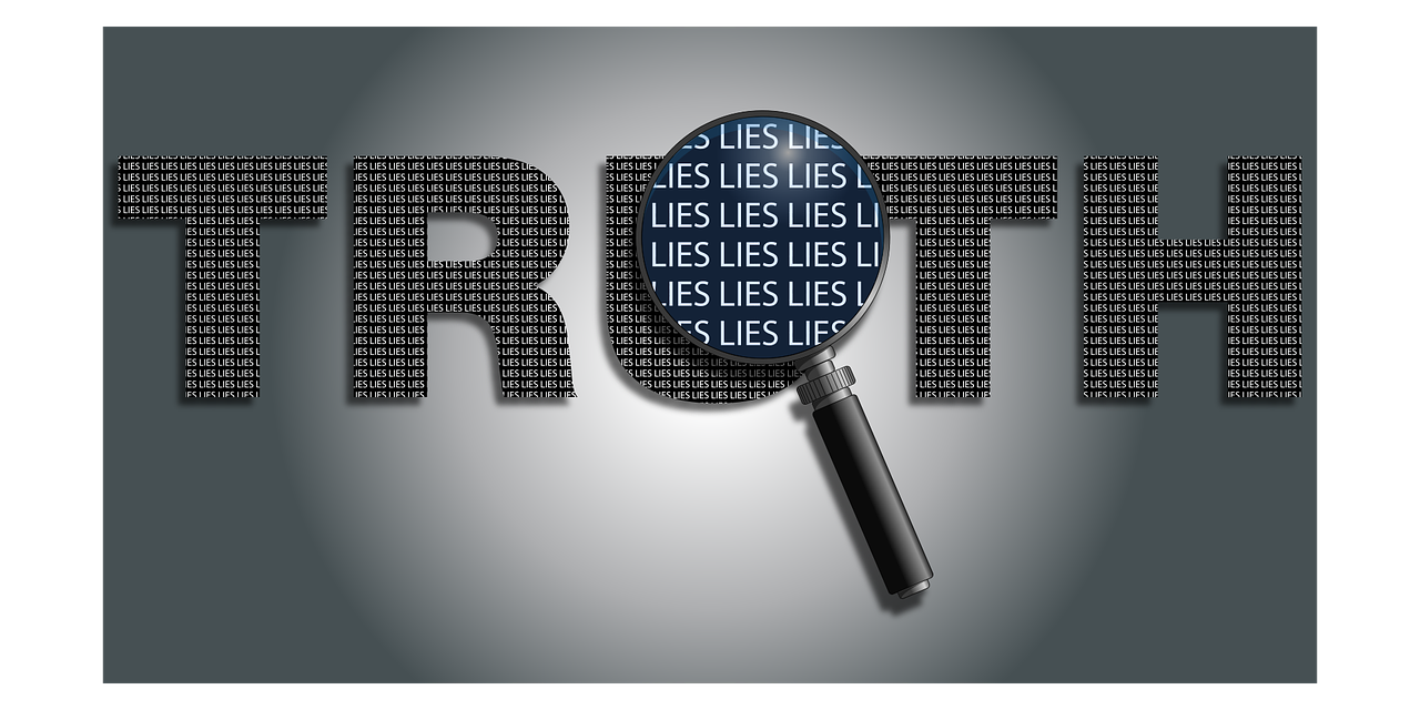 A grey and white graphical image of the word truth superimposed on a dark grey background and a white circular area in the center with a magnifying glass revealing its composition of the word 'lies'