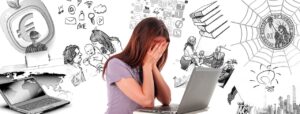 A composite photo and graphical illustration of a young Caucasian woman with long brown hair and a lavender t-shirt leaning against a grey laptop computer with her hands against her face and drawing in black and white of various topics of concern from education to family to finances behind her