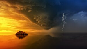 A split picture displaying on the left a calm body of water with a small island and a golden sunset illuminating a broken clouded sky separated by a dark V-shaped cloud and a stormy sky with lightning on the right