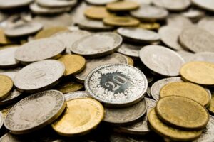 An assorted collection of gold and silver colored Swiss coins