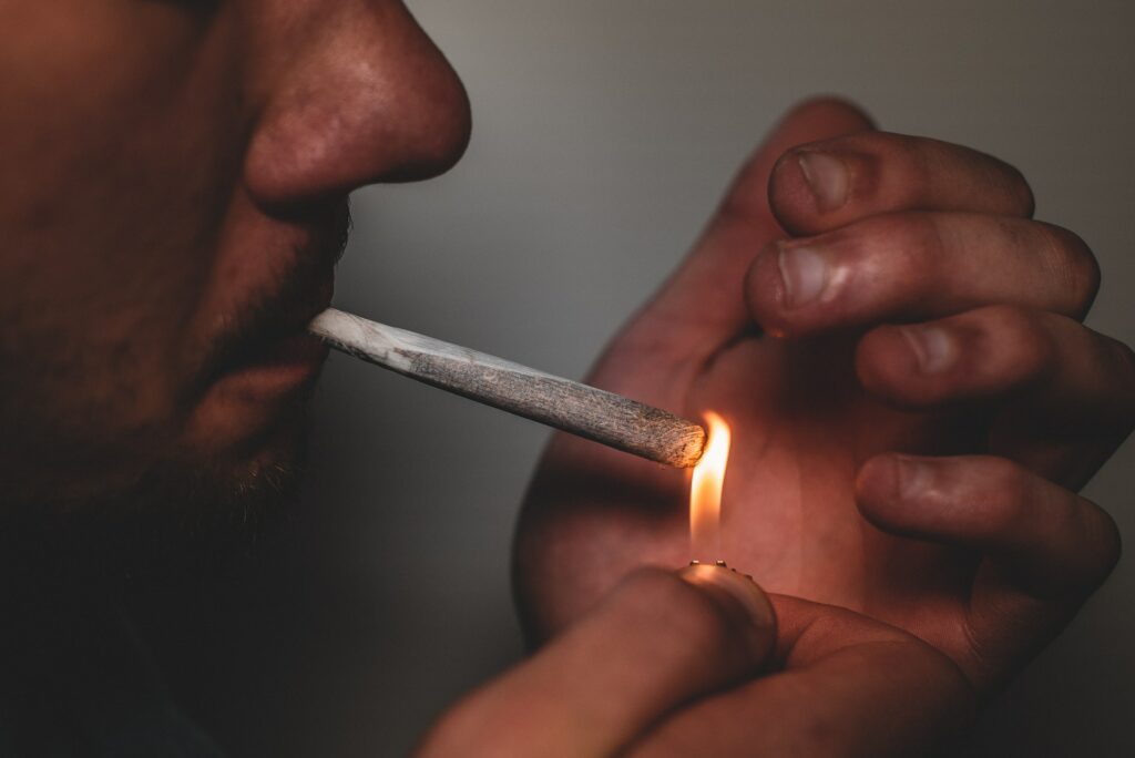A person lighting a joint displaying ironically the liberty they have to be in bondage to drugs but not the liberty in Christ to do as they please