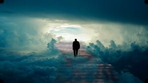 The backside of a older man walking with a cane up a long set of steps with and abundance of clouds surrounding on both sides