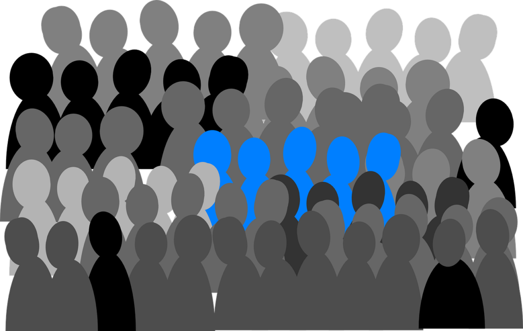 A graphical image of several rows of silhouetted figures in several shades of grey, black and white with one group of five colored in light blue