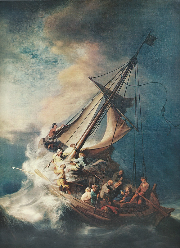 A painting by Rembrandt of Jesus' disciples struggling in a large ship against giant waves and strong winds
