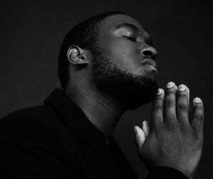 man-praying-bw-pexels-shvets-production-7533332(https:::www.pexels.com:photo:black-man-praying-with-eyes-closed-7533332:)