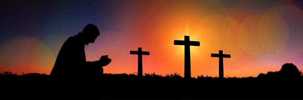graphical silhouette of a person kneeling in prayer with three crosses in the distance against an illuminated twilight background